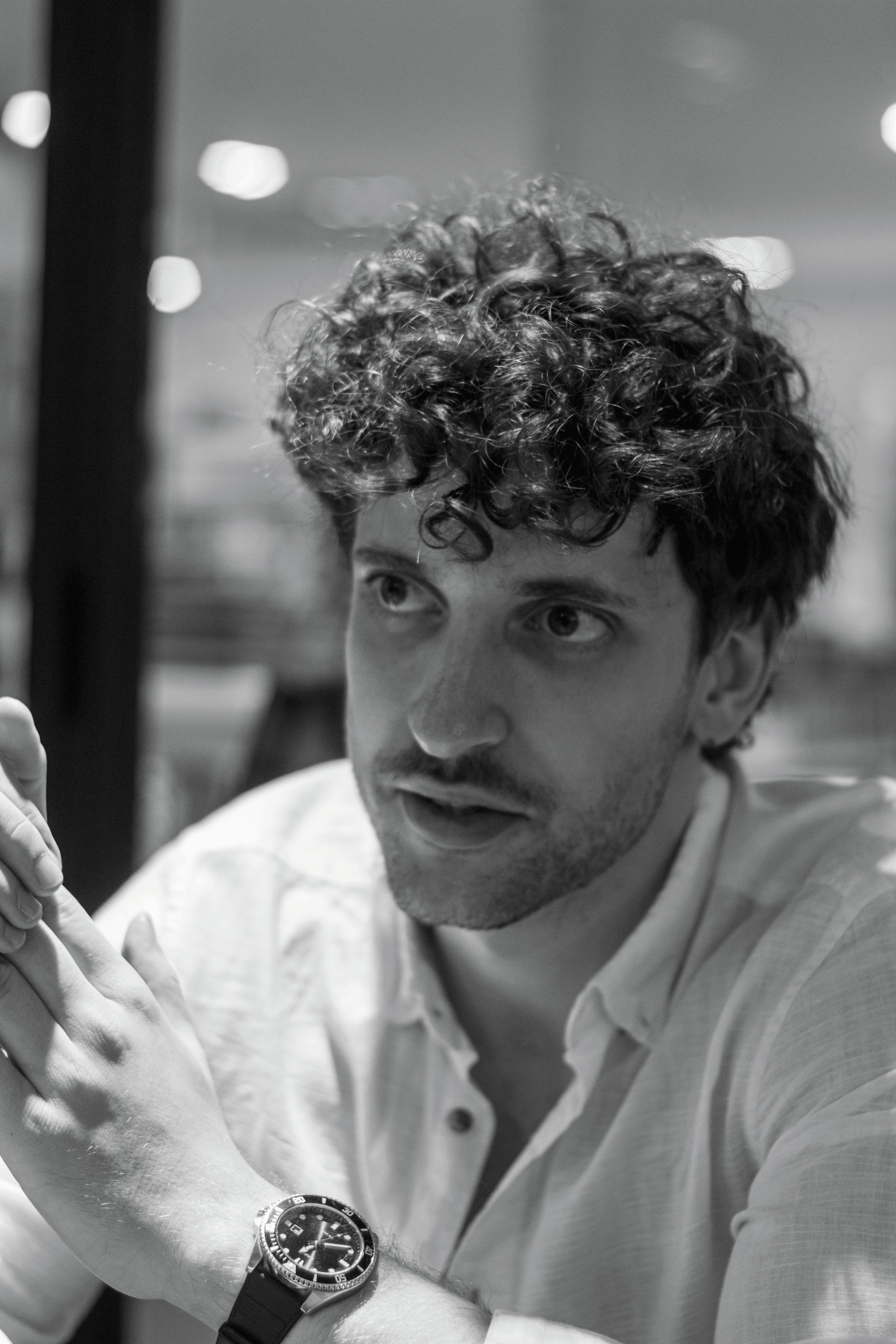 Nick Ambrus mid-conversation during a coaching session, black and white portrait